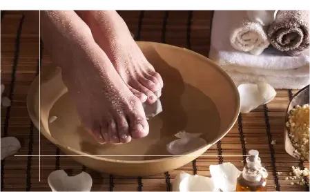 Feet resting on stones in a pedicure bath